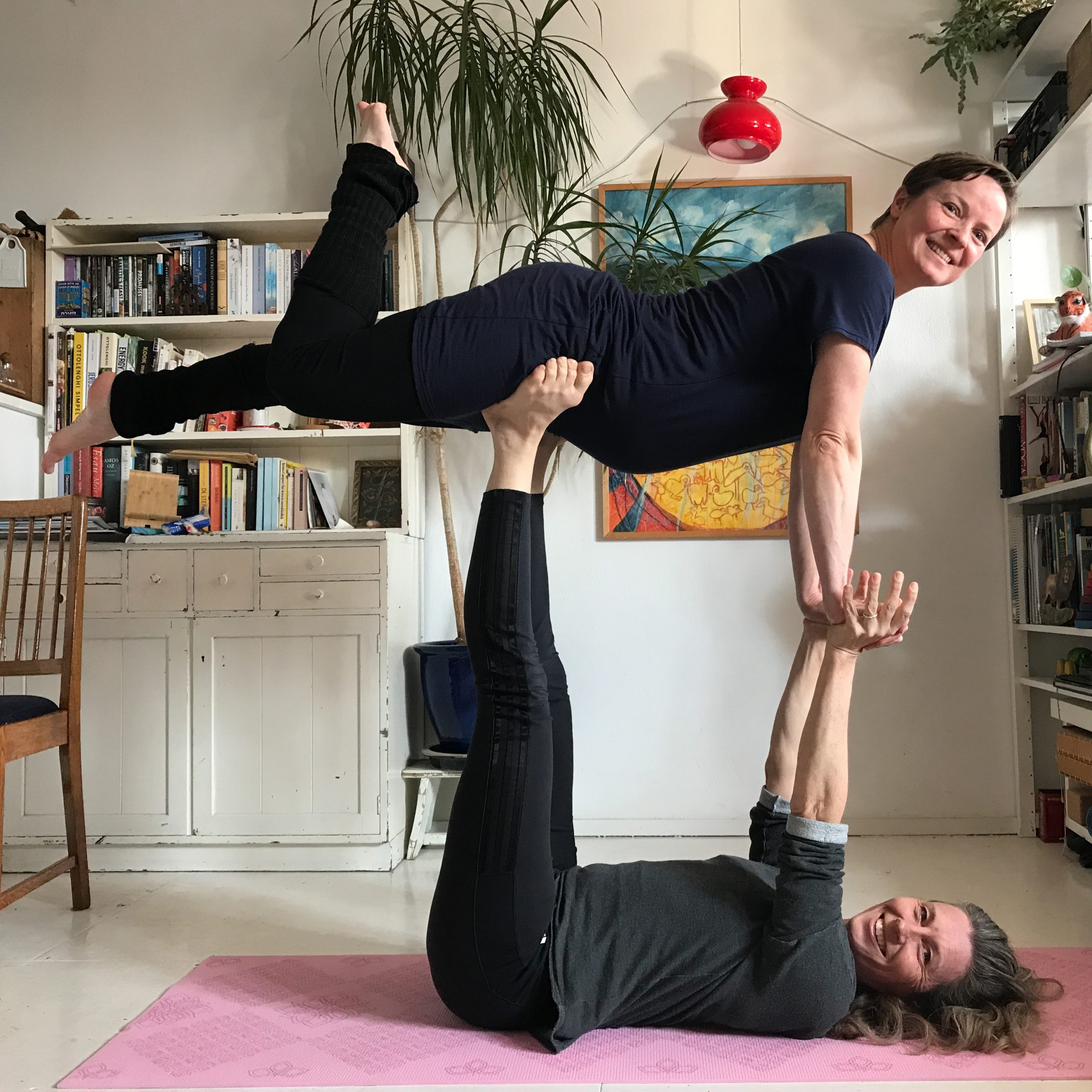 Young couple practicing acro yoga on mat in studio together. Acroyoga. Couple  yoga. Partner yoga. Stock Photo | Adobe Stock